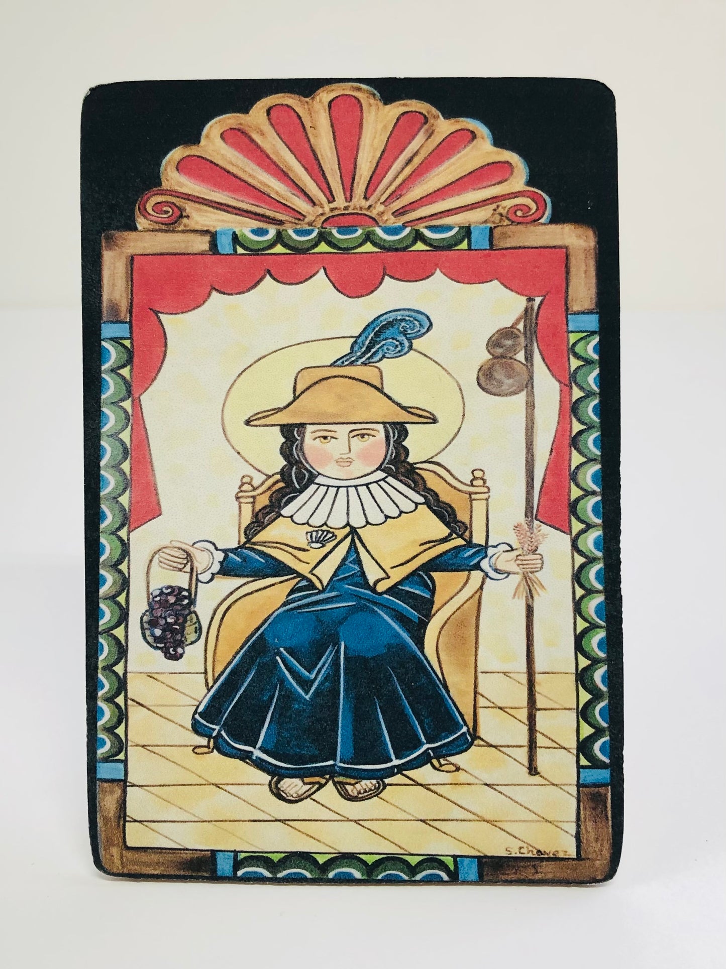 San Pasqual Patron of cooks. chefs, and kitchens. Feast Day: May 17th Retablo is a devotional painting using iconography derived from traditional Catholic church art. Replica is a duplicate of the original artwork. 3.5” X 5” digital photo with protectant on a wood panel. Artist: Shawna Lee Chavez